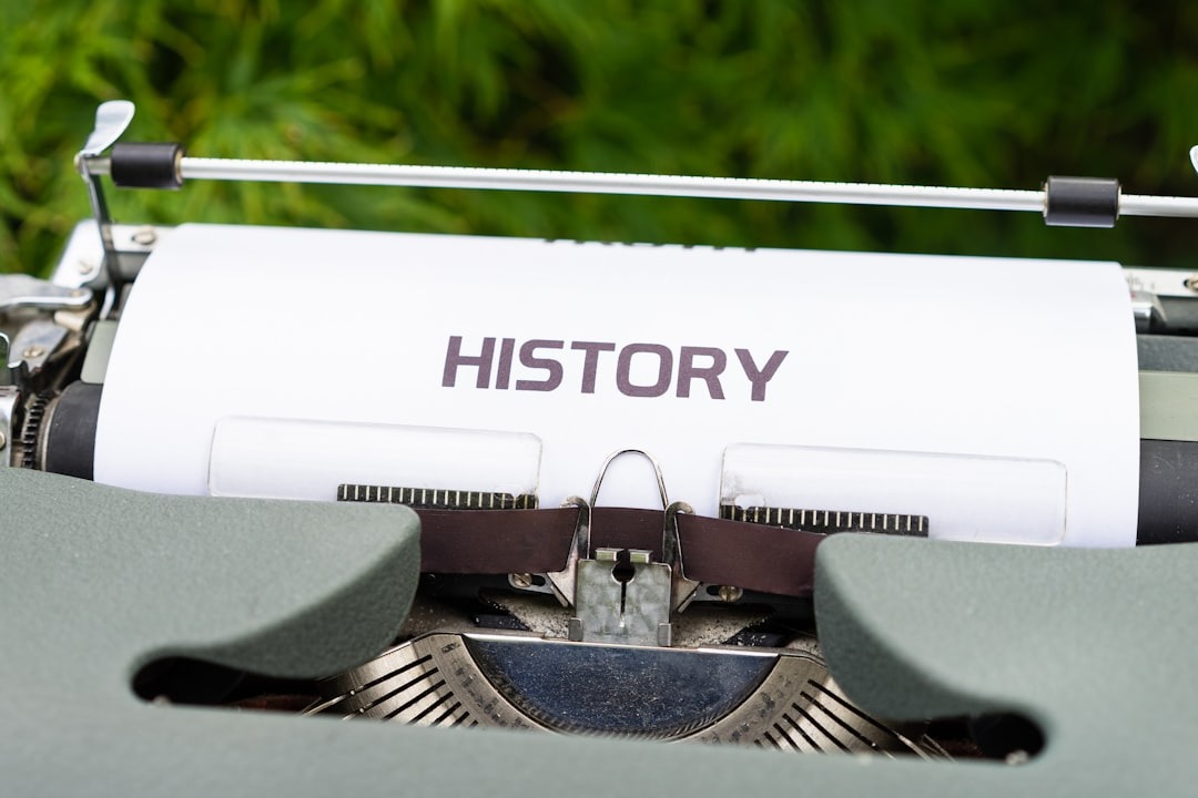Old typewriter with 'HISTORY' typed on paper.