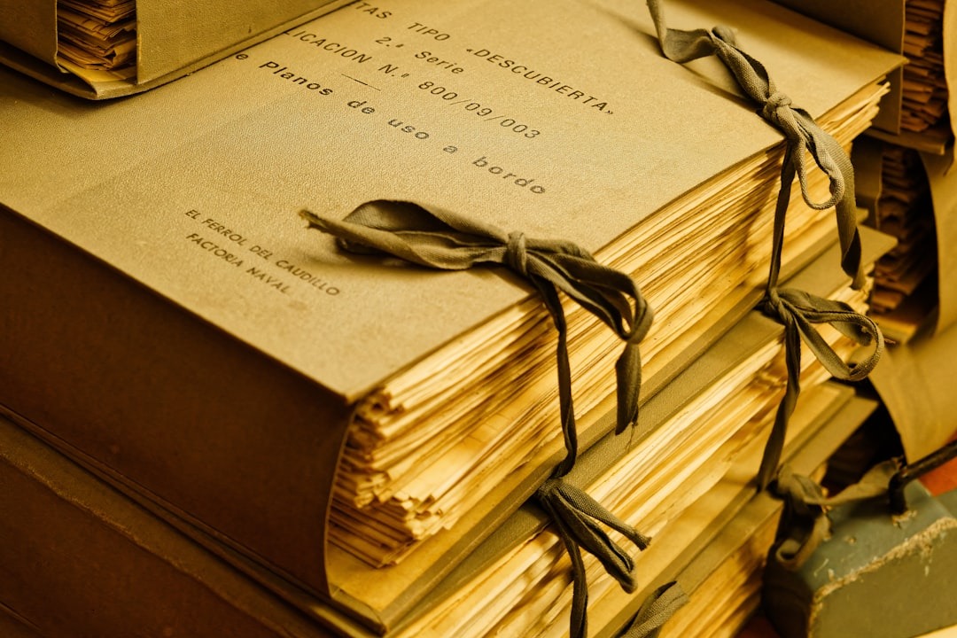Stacked old documents tied with dark ribbon.